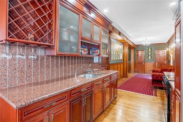 3821 Avenue S, Brooklyn, NY 11234 - bar featuring a notable chandelier, light wood-style flooring, a sink, indoor bar, and decorative backsplash