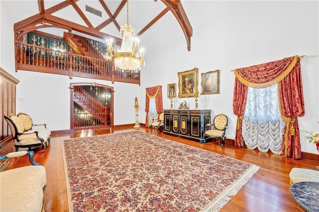 3821 Avenue S, Brooklyn, NY 11234 - living room with wood finished floors, beam ceiling, high vaulted ceiling, visible vents, and an inviting chandelier