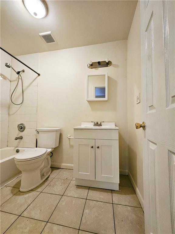 bathroom with visible vents, tile patterned flooring, baseboards, vanity, and toilet