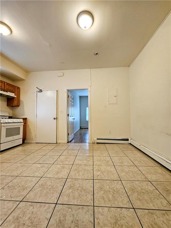 interior space featuring light tile patterned floors and baseboard heating
