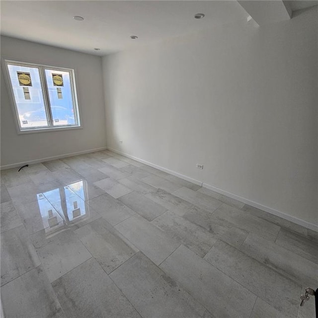 empty room with baseboards