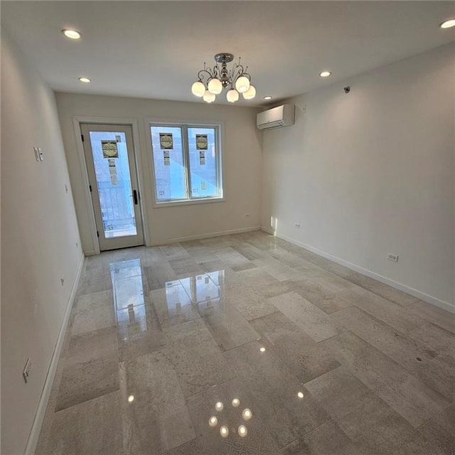 unfurnished dining area with an inviting chandelier, baseboards, a wall mounted AC, and recessed lighting