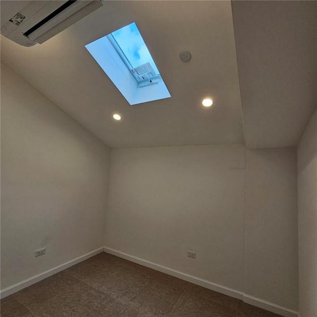 additional living space featuring a skylight, baseboards, and recessed lighting