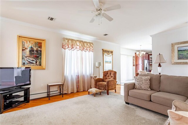 525 Falcon Ave, Staten Island, NY 10306 - living room with a chandelier, baseboard heating, crown molding, ceiling fan, and wood finished floors