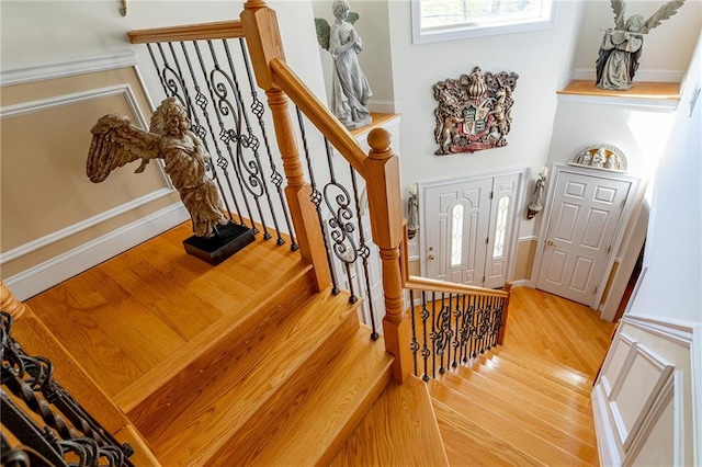 stairs featuring wood finished floors