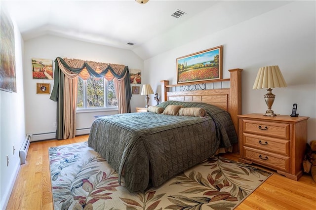 bedroom with visible vents, lofted ceiling, and light wood finished floors
