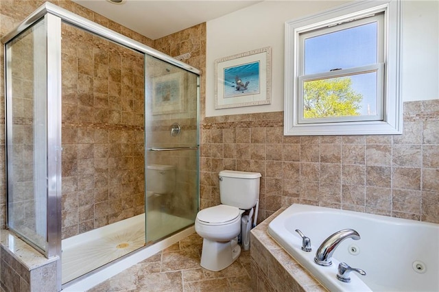 bathroom featuring tile walls, a shower stall, a tub with jets, and toilet