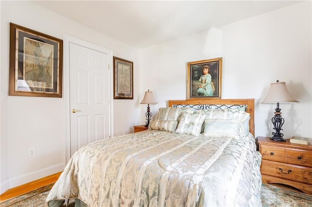 bedroom with baseboards and wood finished floors