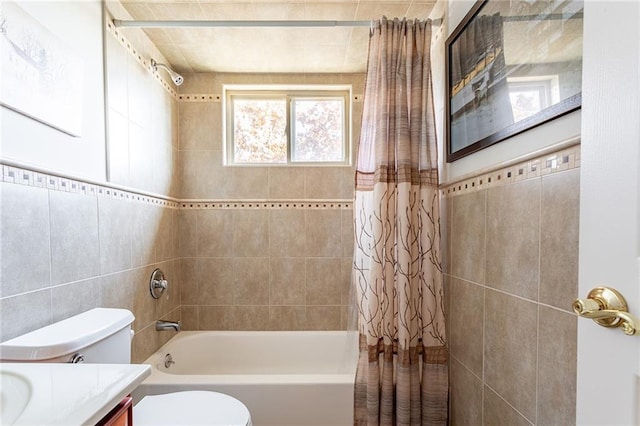 bathroom featuring vanity, tile walls, shower / bath combo, and toilet