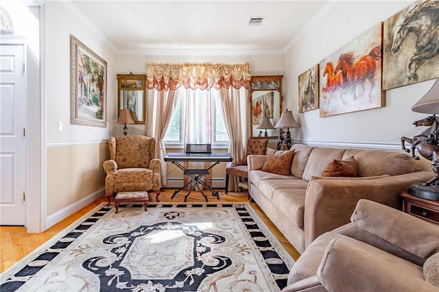 living area with crown molding, baseboards, wood finished floors, and visible vents