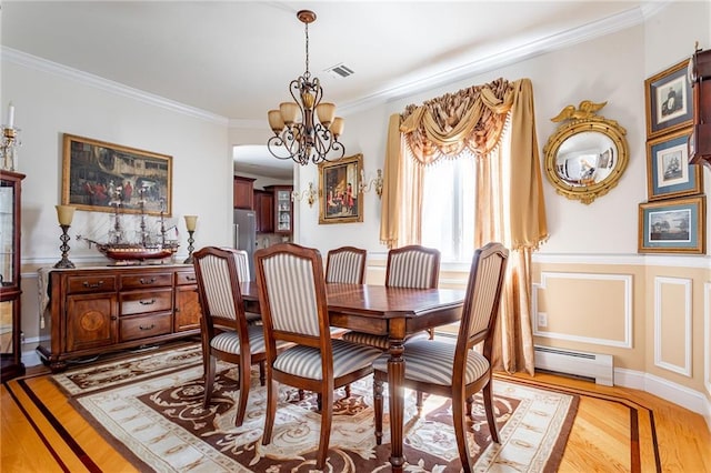 dining space featuring light wood-style floors, visible vents, crown molding, a baseboard heating unit, and an inviting chandelier