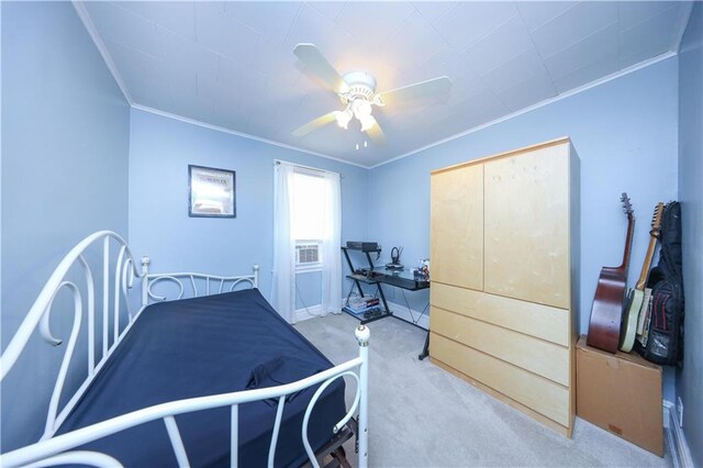 bedroom featuring crown molding, baseboards, ceiling fan, and light colored carpet