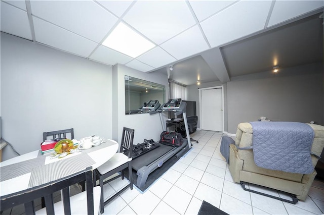 living area featuring baseboards and light tile patterned floors