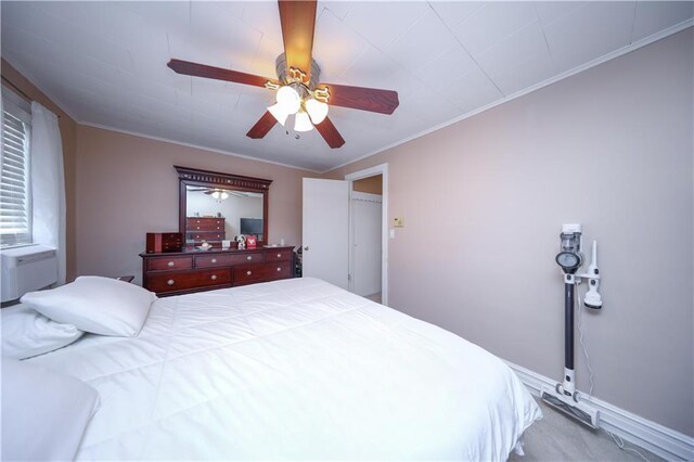 bedroom with carpet floors, a ceiling fan, and ornamental molding
