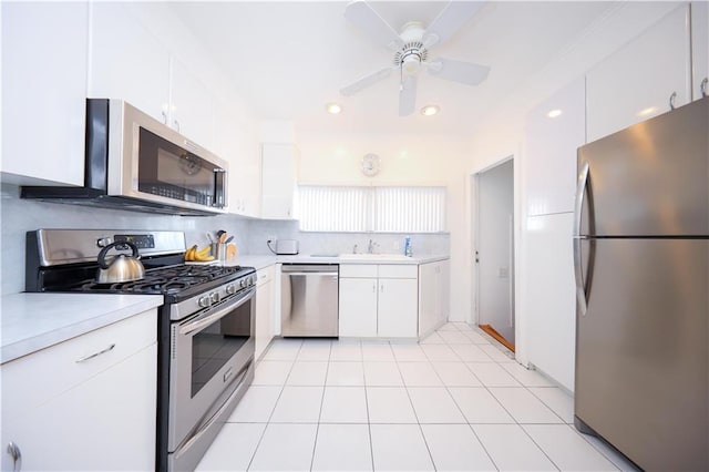 kitchen with light countertops, appliances with stainless steel finishes, a ceiling fan, and white cabinetry