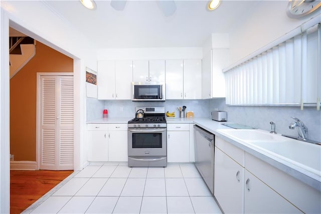 kitchen featuring light countertops, appliances with stainless steel finishes, and white cabinetry