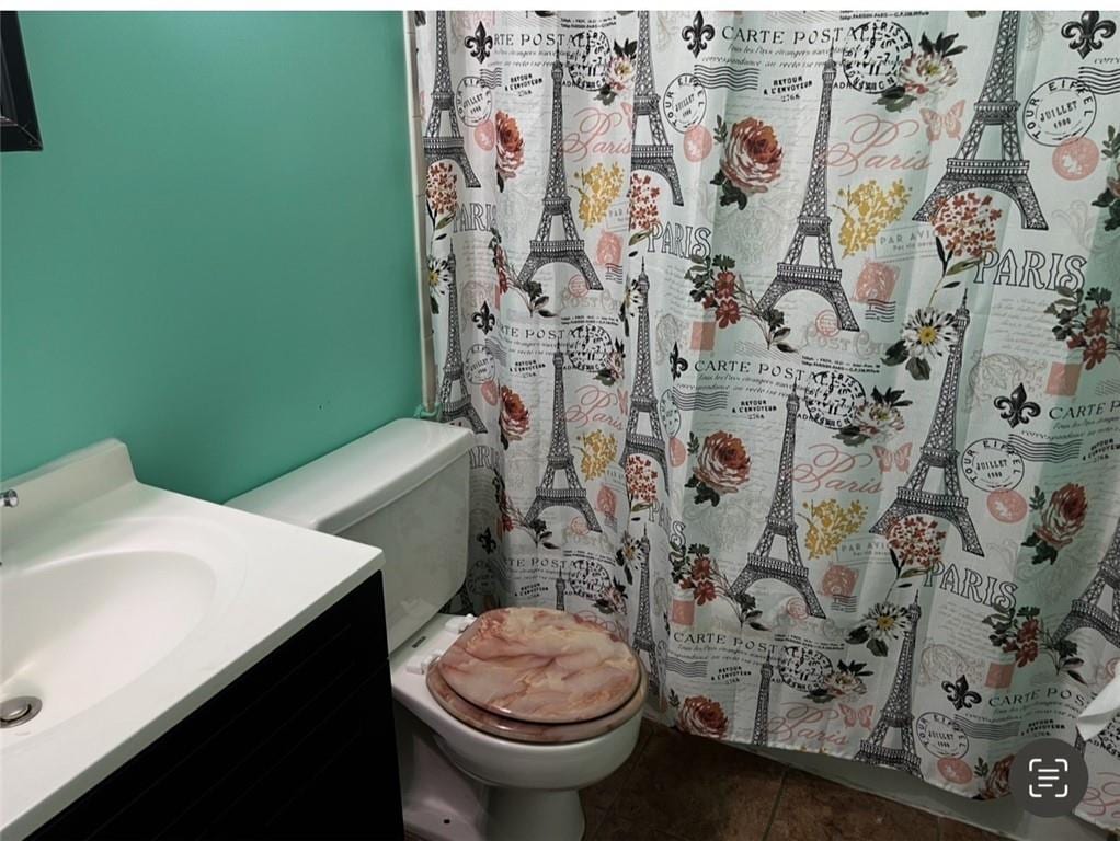 bathroom with vanity, tile patterned floors, and toilet