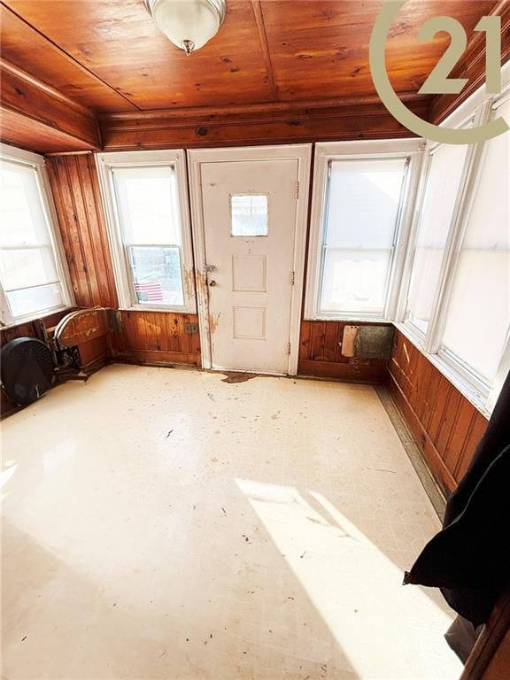 entryway featuring wooden walls and wood ceiling