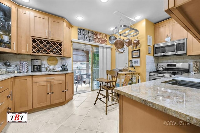 1854 73rd St, Brooklyn, NY 11204 - kitchen with appliances with stainless steel finishes, decorative backsplash, light stone countertops, light tile patterned floors, and recessed lighting