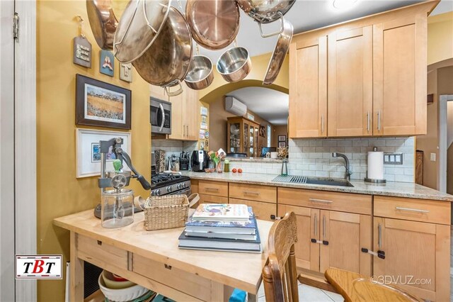 1854 73rd St, Brooklyn, NY 11204 - kitchen with arched walkways, appliances with stainless steel finishes, a sink, and backsplash