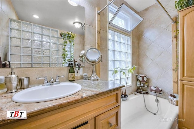 1854 73rd St, Brooklyn, NY 11204 - full bathroom with vanity, tile walls, plenty of natural light, and a skylight