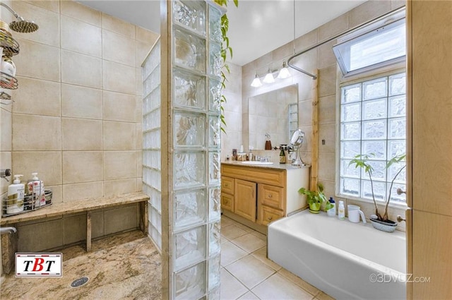 1854 73rd St, Brooklyn, NY 11204 - bathroom with tile walls, tile patterned floors, a garden tub, healthy amount of natural light, and a skylight