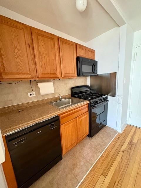 9255 Shore Rd Unit 6C, Brooklyn, NY 11209 - kitchen featuring black appliances, decorative backsplash, brown cabinets, and light wood finished floors