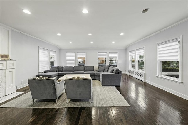 living room featuring wood-type flooring, baseboards, ornamental molding, and plenty of natural light