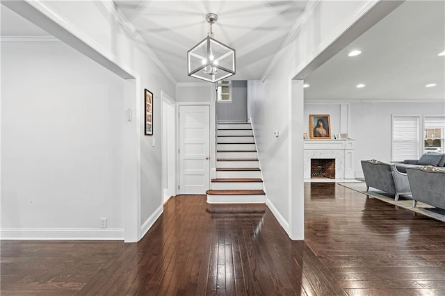 entrance foyer with crown molding, stairway, baseboards, wood-type flooring, and recessed lighting