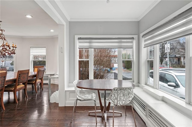 dining area with crown molding, recessed lighting, and dark wood finished floors