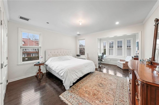 bedroom with crown molding, multiple windows, dark wood finished floors, and visible vents