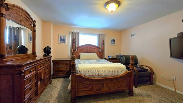 bedroom with baseboards, visible vents, and dark colored carpet