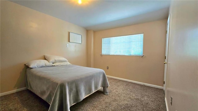 bedroom featuring carpet floors and baseboards