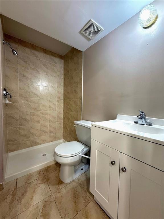 bathroom featuring visible vents, vanity, toilet, tile patterned floors, and a shower stall