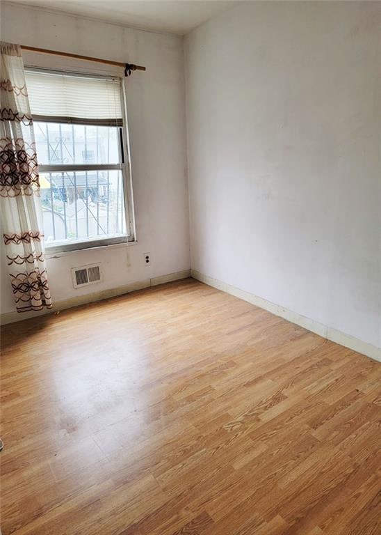 2878 W 31st St, Brooklyn, NY 11224 - unfurnished room with light wood finished floors and baseboards
