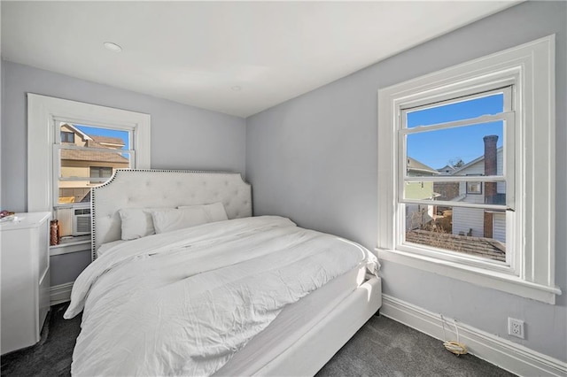 bedroom with baseboards, cooling unit, and dark carpet
