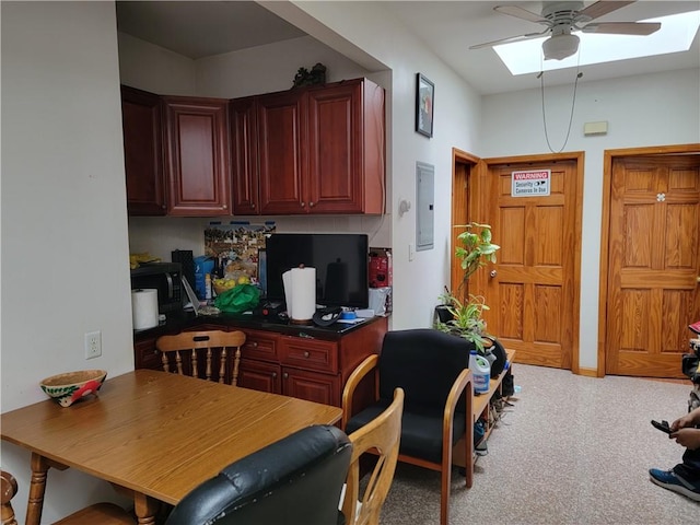 interior space featuring carpet flooring, a skylight, ceiling fan, and electric panel