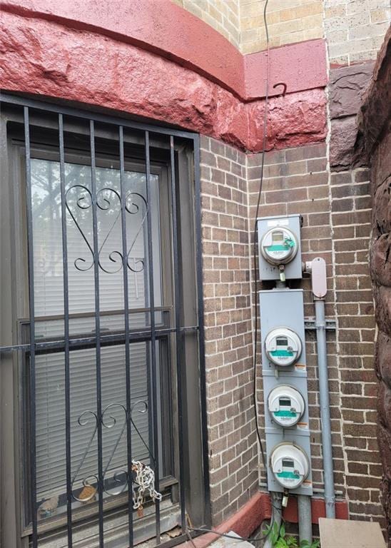 exterior details with brick siding and electric meter