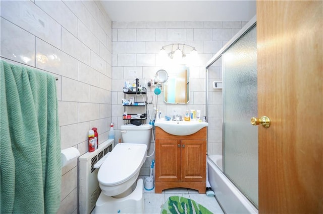 bathroom with vanity, tile patterned floors, toilet, and tile walls