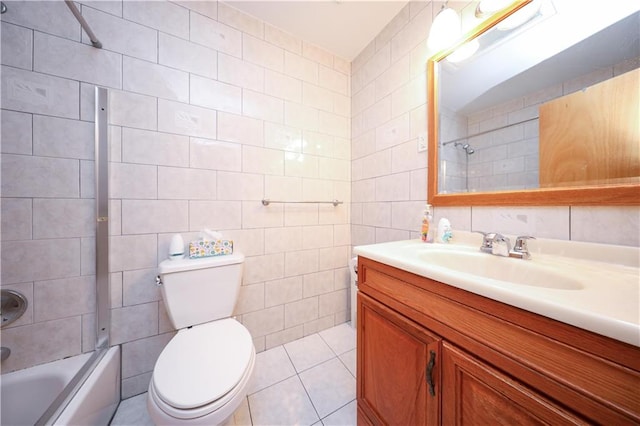 full bath featuring shower / bathing tub combination, tile walls, tile patterned floors, vanity, and toilet