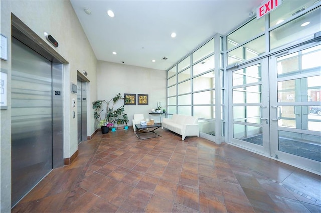 interior space with french doors and elevator