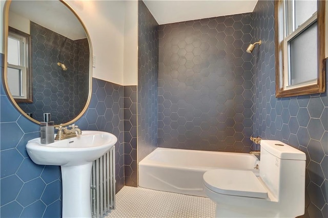 bathroom featuring tile walls, tile patterned floors, toilet, and shower / tub combination