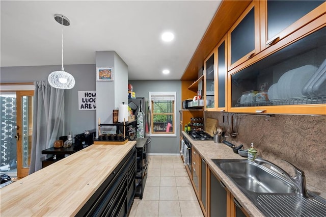 1942 Kimball St, Brooklyn, NY 11234 - kitchen with wooden counters, appliances with stainless steel finishes, glass insert cabinets, decorative light fixtures, and light tile patterned flooring