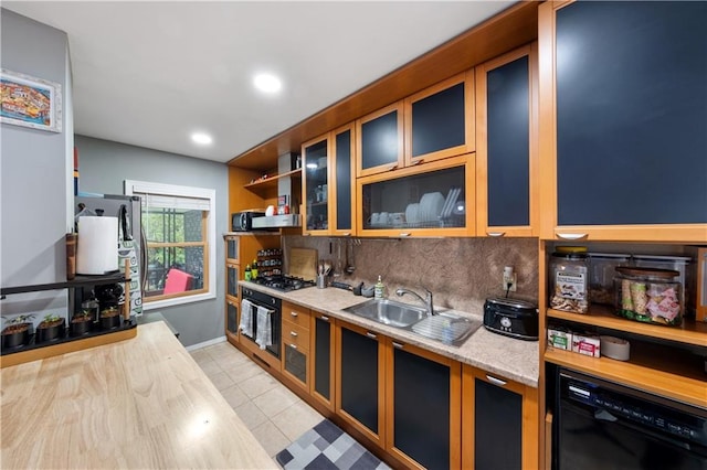 1942 Kimball St, Brooklyn, NY 11234 - kitchen featuring black appliances, light countertops, backsplash, a sink, and light tile patterned floors