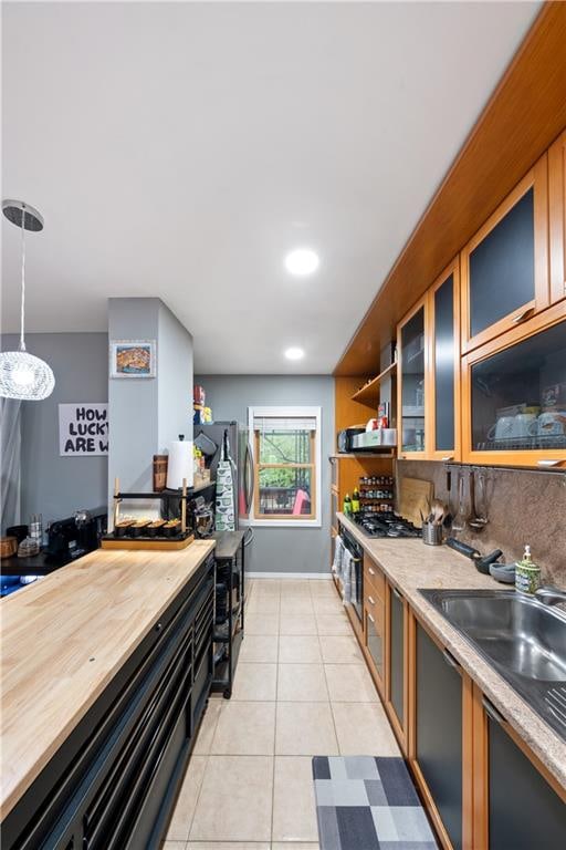 1942 Kimball St, Brooklyn, NY 11234 - kitchen with wood counters, glass insert cabinets, light tile patterned flooring, open shelves, and pendant lighting