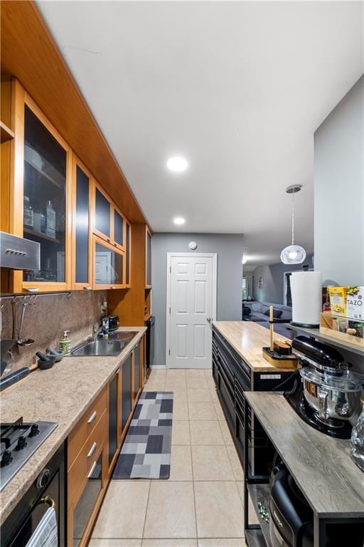 1942 Kimball St, Brooklyn, NY 11234 - kitchen with a sink, glass insert cabinets, stainless steel gas stovetop, light countertops, and oven