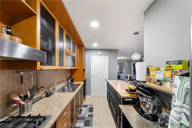 1942 Kimball St, Brooklyn, NY 11234 - kitchen featuring exhaust hood, stainless steel gas stovetop, light countertops, a sink, and hanging light fixtures