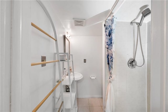 1942 Kimball St, Brooklyn, NY 11234 - bathroom featuring a tile shower, tile patterned flooring, and baseboards