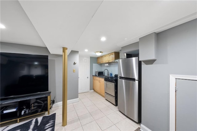 1942 Kimball St, Brooklyn, NY 11234 - kitchen with freestanding refrigerator, gas stove, baseboards, light tile patterned floors, and backsplash