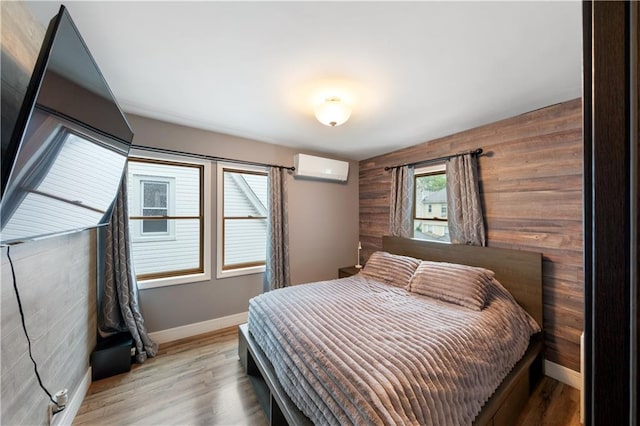 1942 Kimball St, Brooklyn, NY 11234 - bedroom with baseboards, a wall mounted AC, wood finished floors, and wooden walls